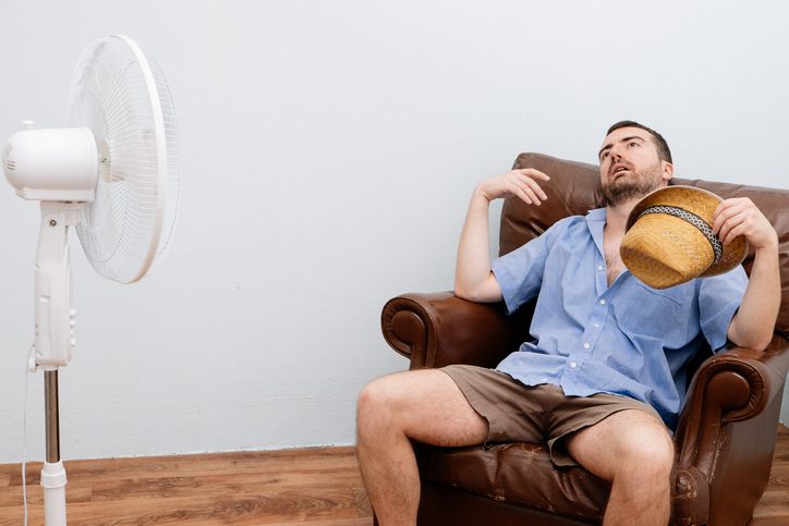 American Air Heating & Cooling | Rock Hill, SC | flushed man feeling hot in front of fan